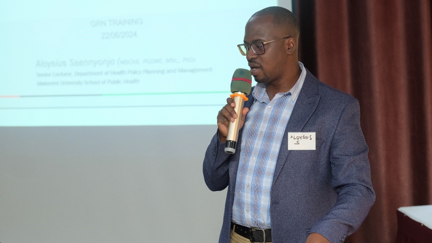 Dr Aloysius Senyonjo , a health policy expert and senior lecturer  at the Dept of Health Policy Planning and Mgt at Makerere University School of Public Health delivering the training to the participants