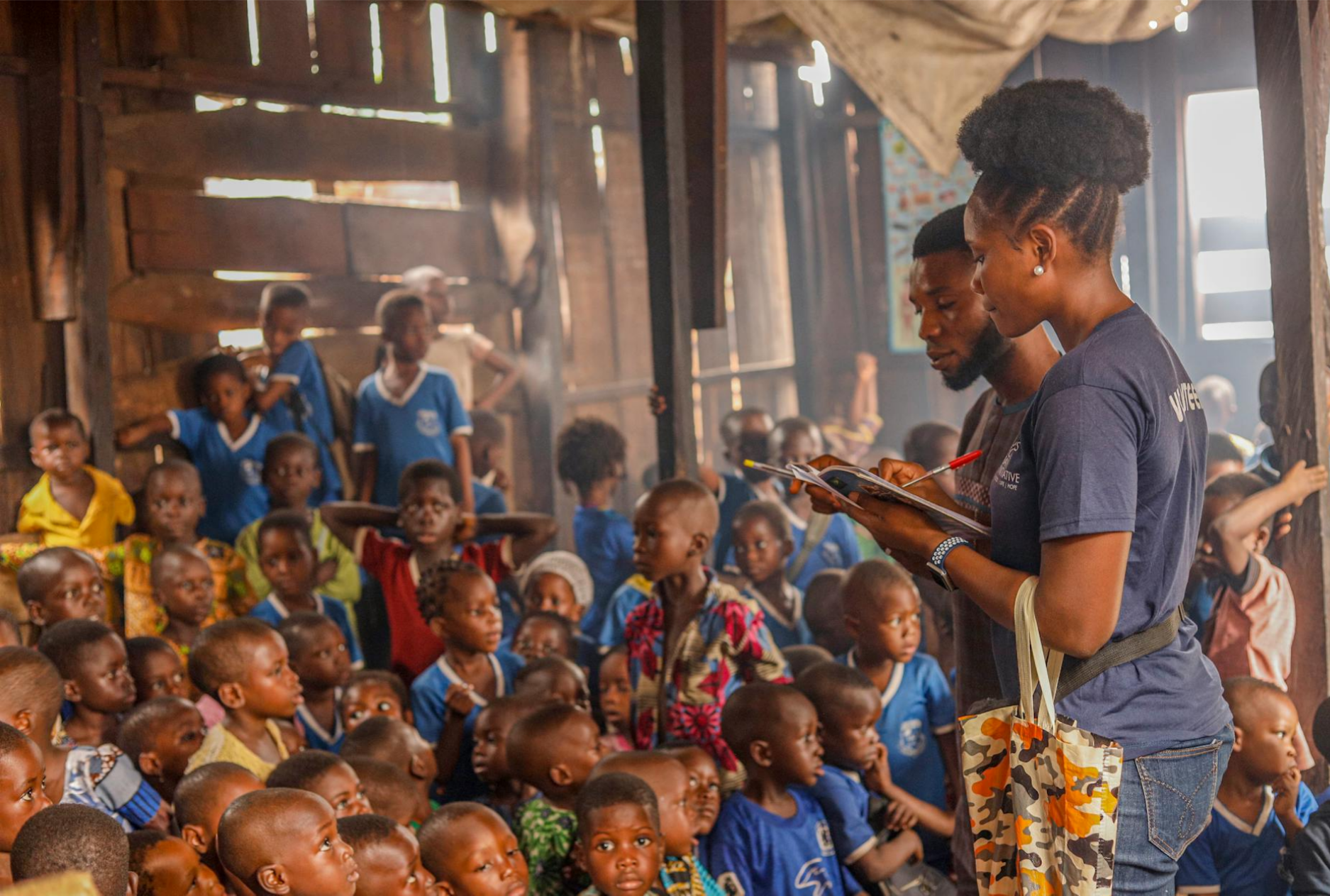 Community volunteers with group of children