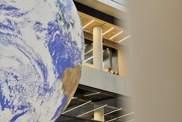 UCL Brand photography of globe and people in background